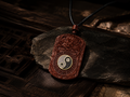 Carved wooden yin-yang pendant